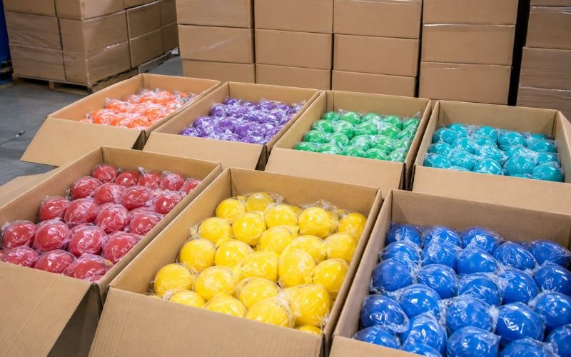 Bulk boxes of therapeutic squeeze balls staged for wholesale export to clinics in Nairobi and Lagos
